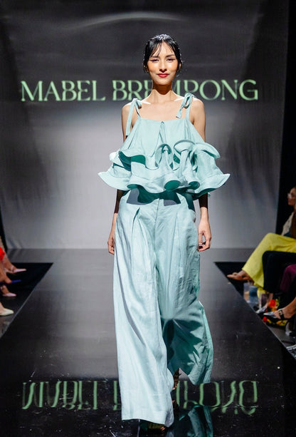 Model wearing 100% Linen Trousers from Mabel Brempong in Mint with a ruffle top as a set